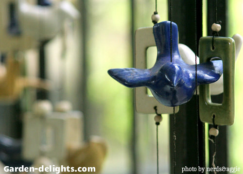 Bluebird wind chime with the wings spread and white, green rectangle shapes, bird ceramic wind chimes, decorative animal wind chimes.